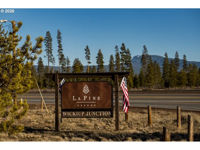 a view of a wooden fence and a sign board