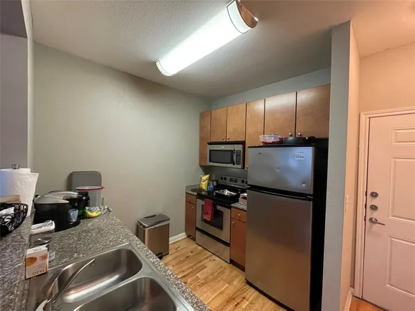 a kitchen with a refrigerator and a sink