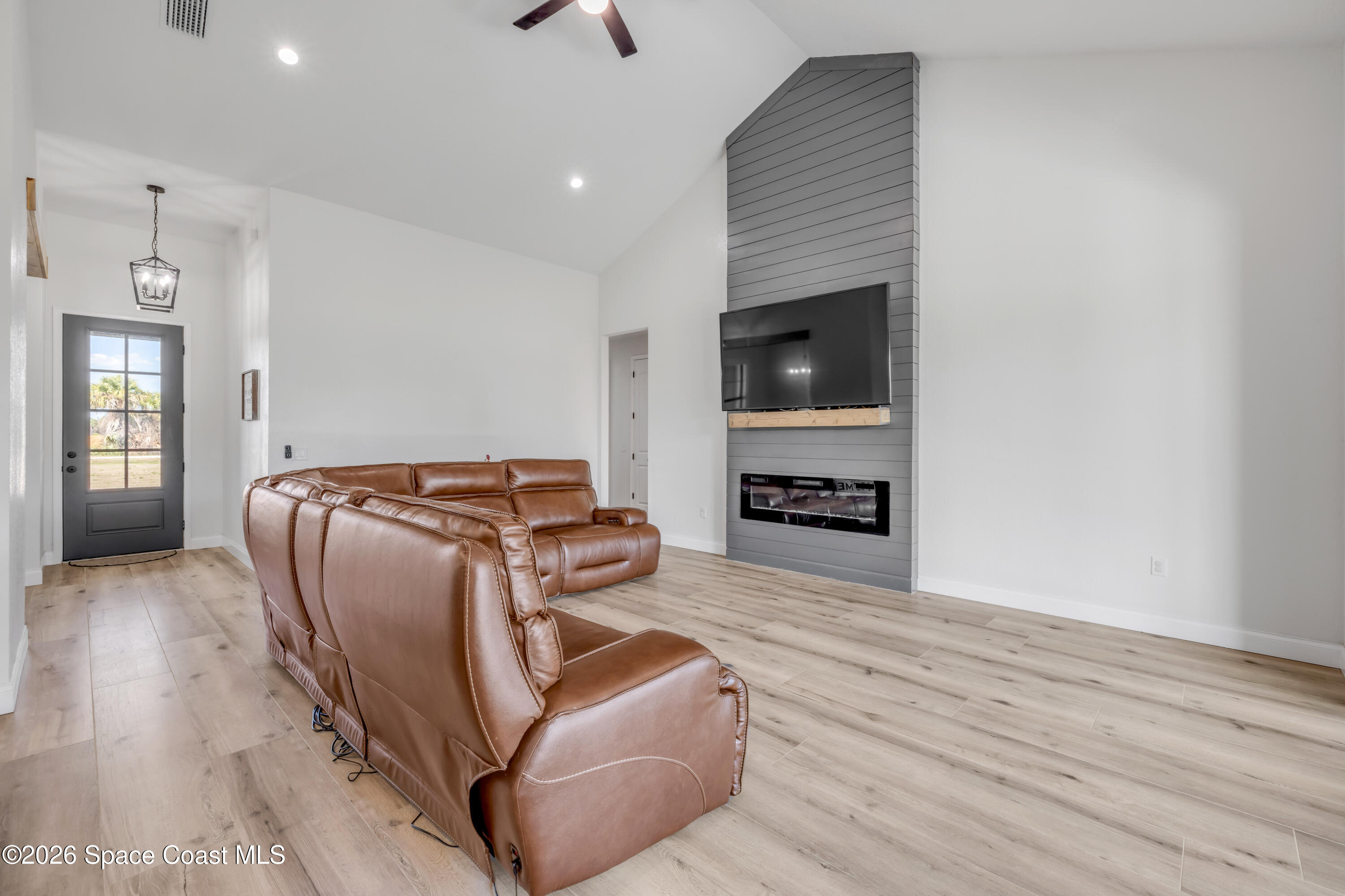 3395 Dunn Road Mims, FL 32754 - Photo 12 of 40 a living room with furniture and a flat screen tv