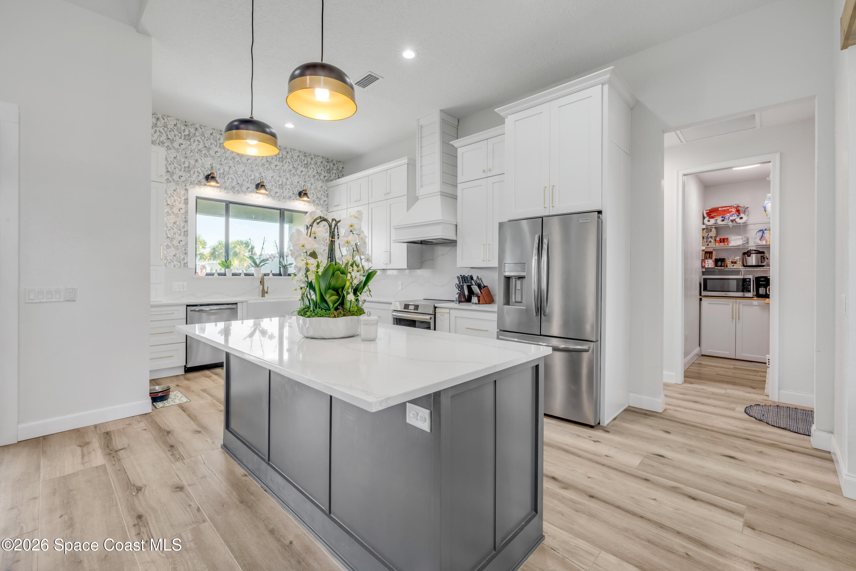 3395 Dunn Road Mims, FL 32754 - Photo 13 of 40 a kitchen with a sink stainless steel appliances a refrigerator and a stove top oven
