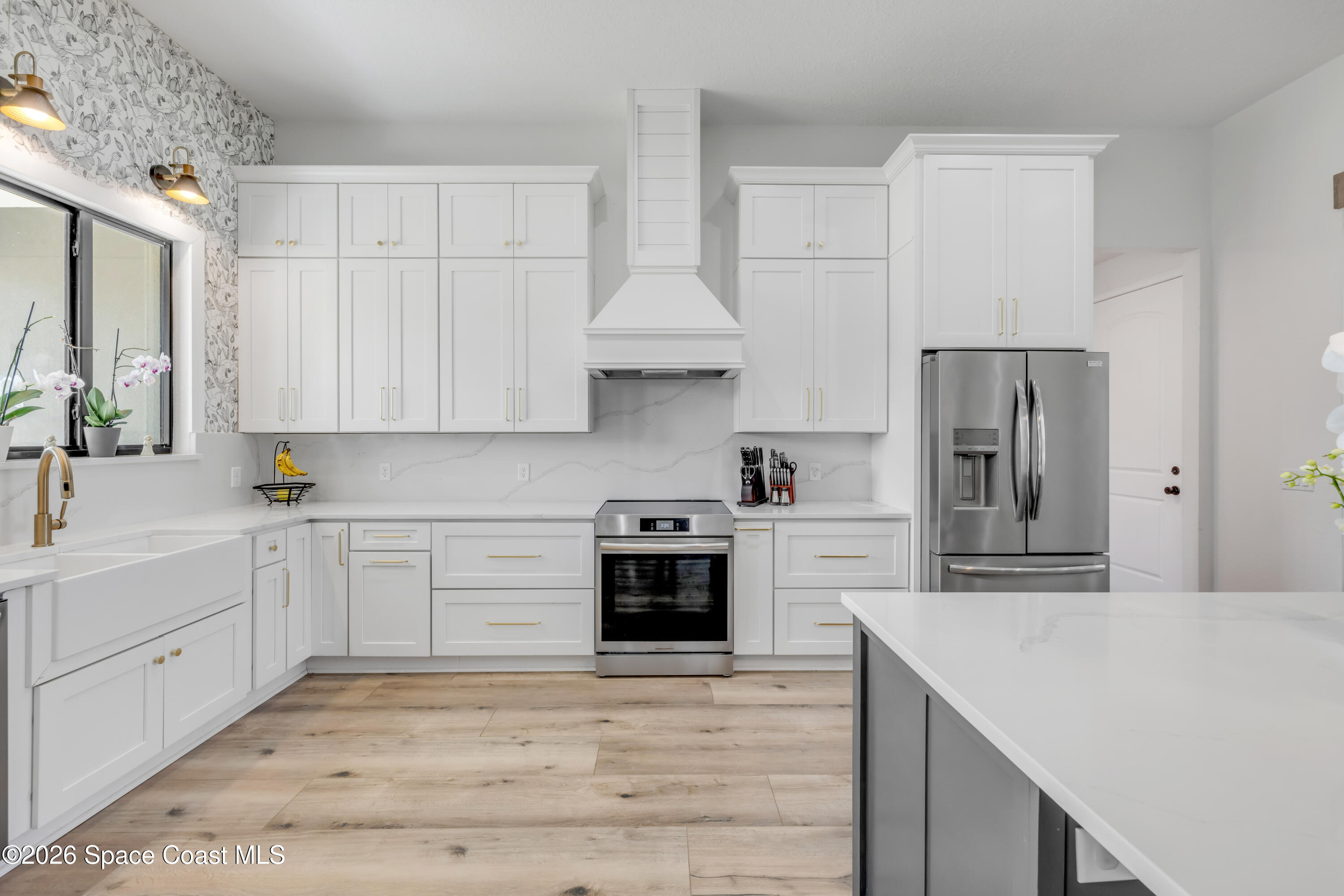 3395 Dunn Road Mims, FL 32754 - Photo 16 of 40 a kitchen with stainless steel appliances granite countertop a stove and white cabinets