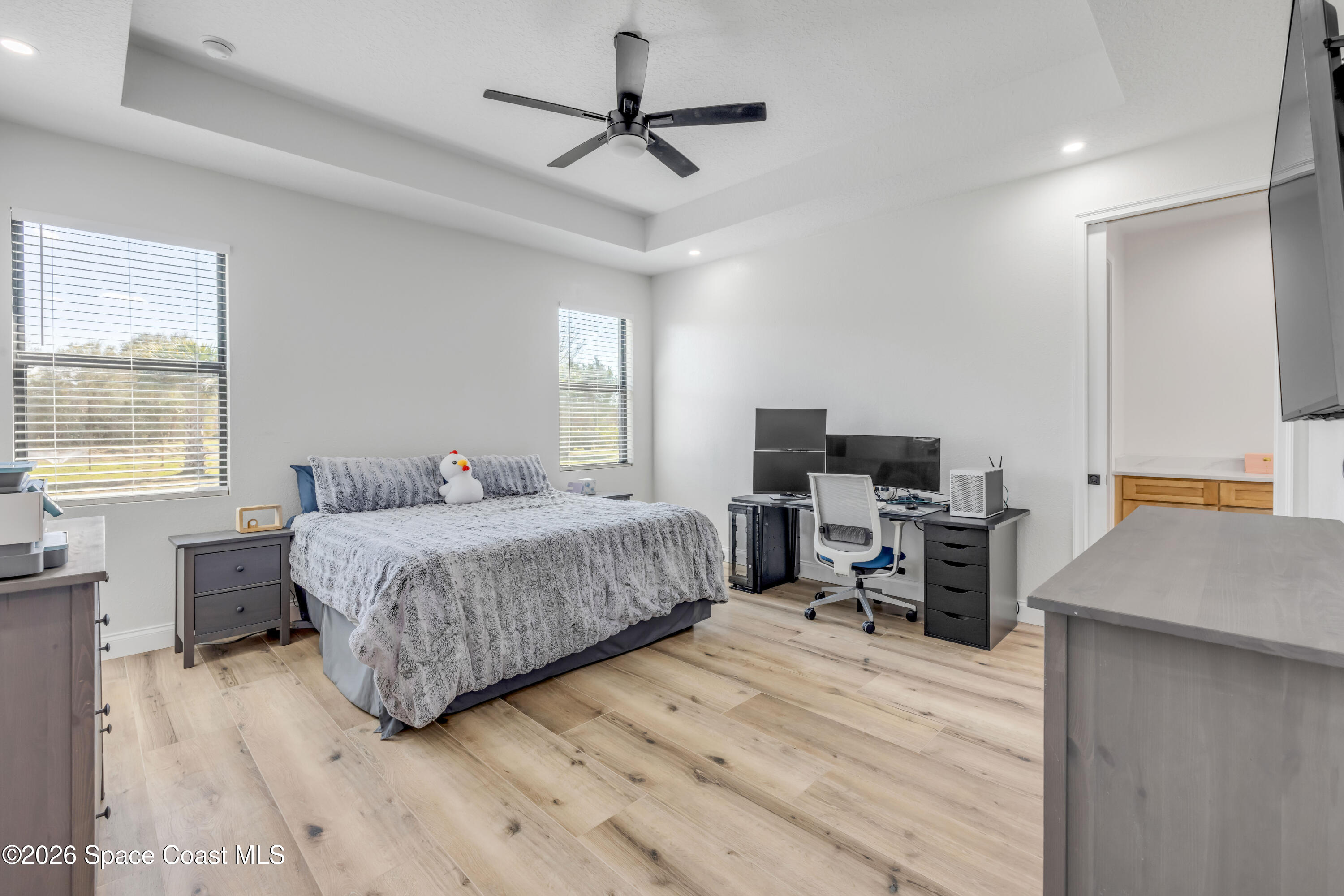 3395 Dunn Road Mims, FL 32754 - Photo 19 of 40 a bedroom with a bed and a flat screen tv