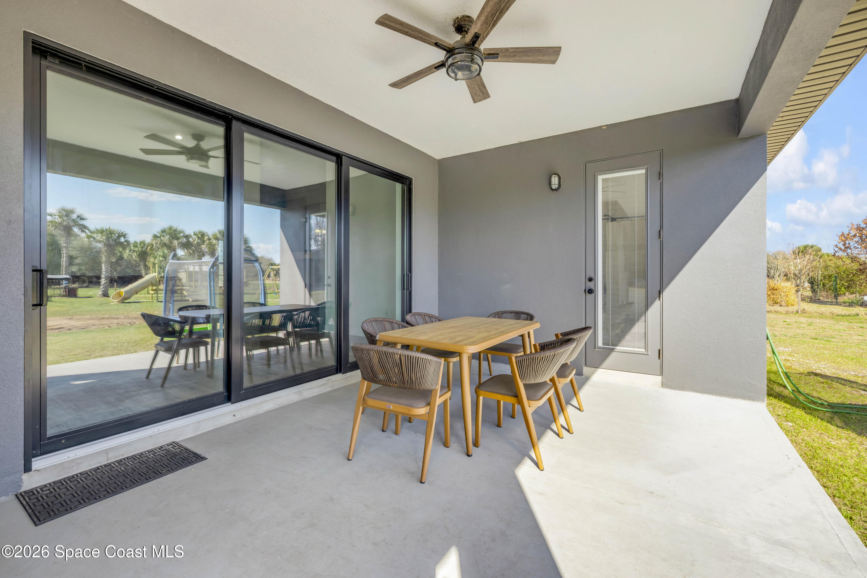 3395 Dunn Road Mims, FL 32754 - Photo 30 of 40 a dining room with furniture and a floor to ceiling window