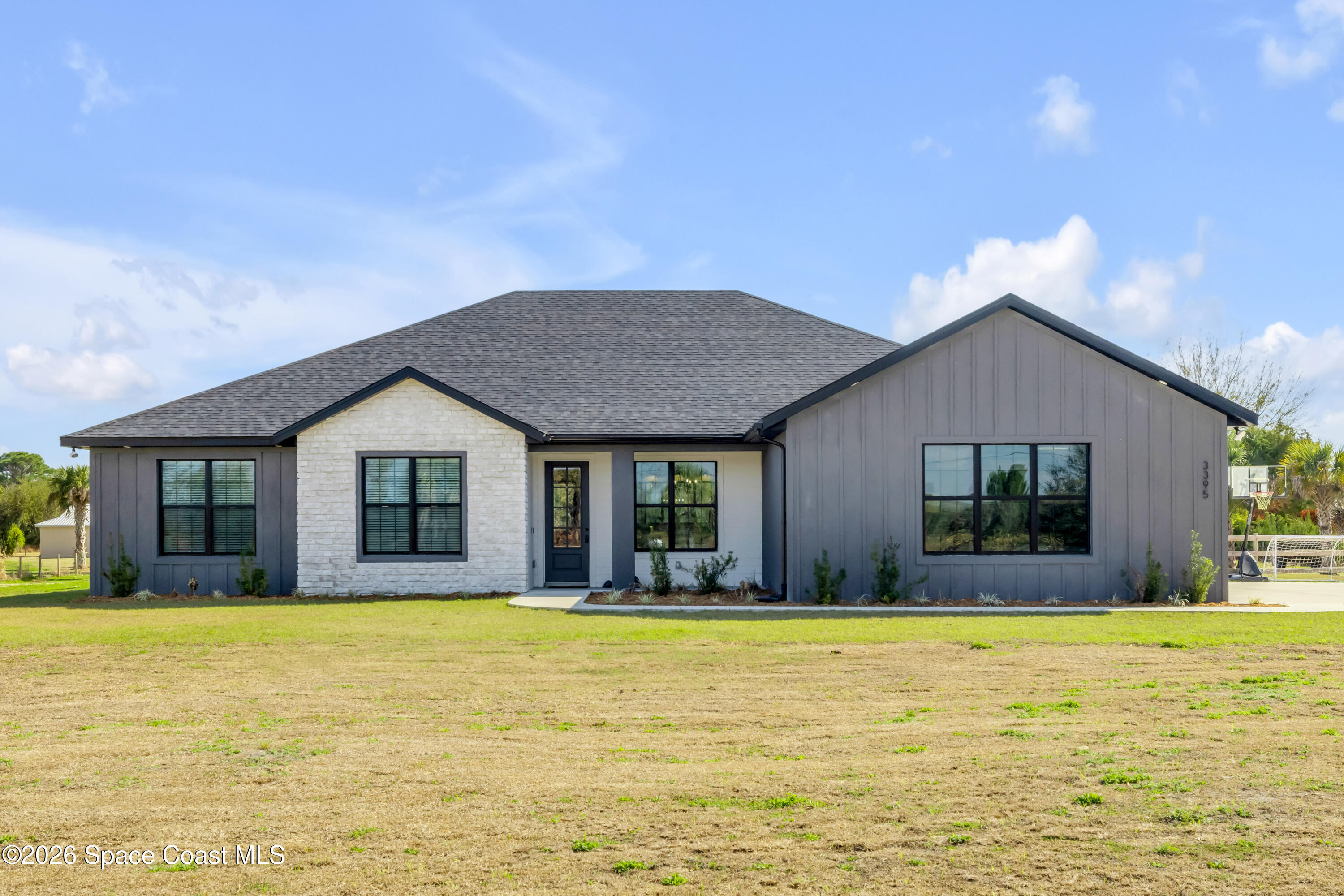 3395 Dunn Road Mims, FL 32754 - Photo 3 of 40 a house view with swimming pool in front of it