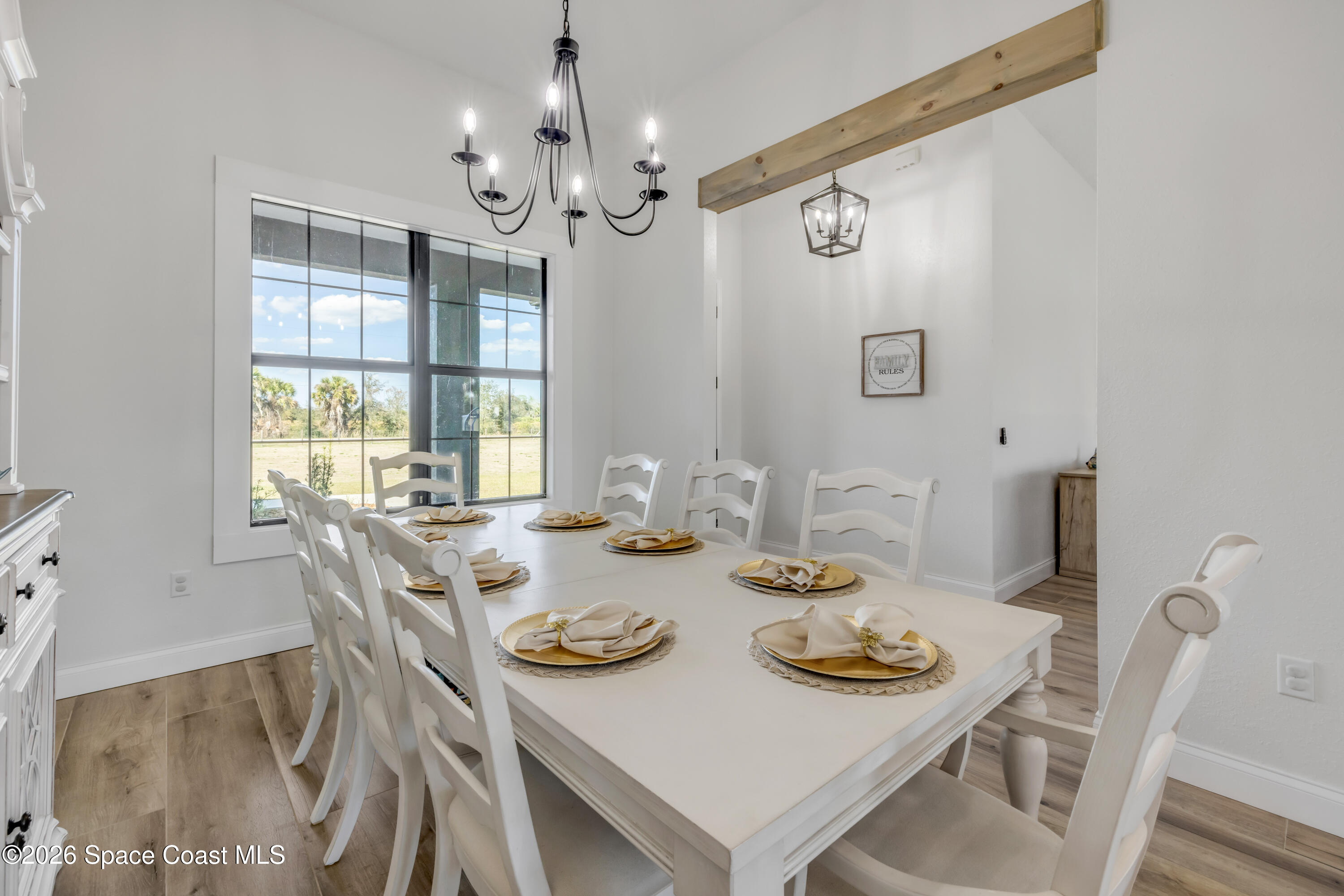 3395 Dunn Road Mims, FL 32754 - Photo 7 of 40 a view of a dining room with furniture a chandelier and wooden floor
