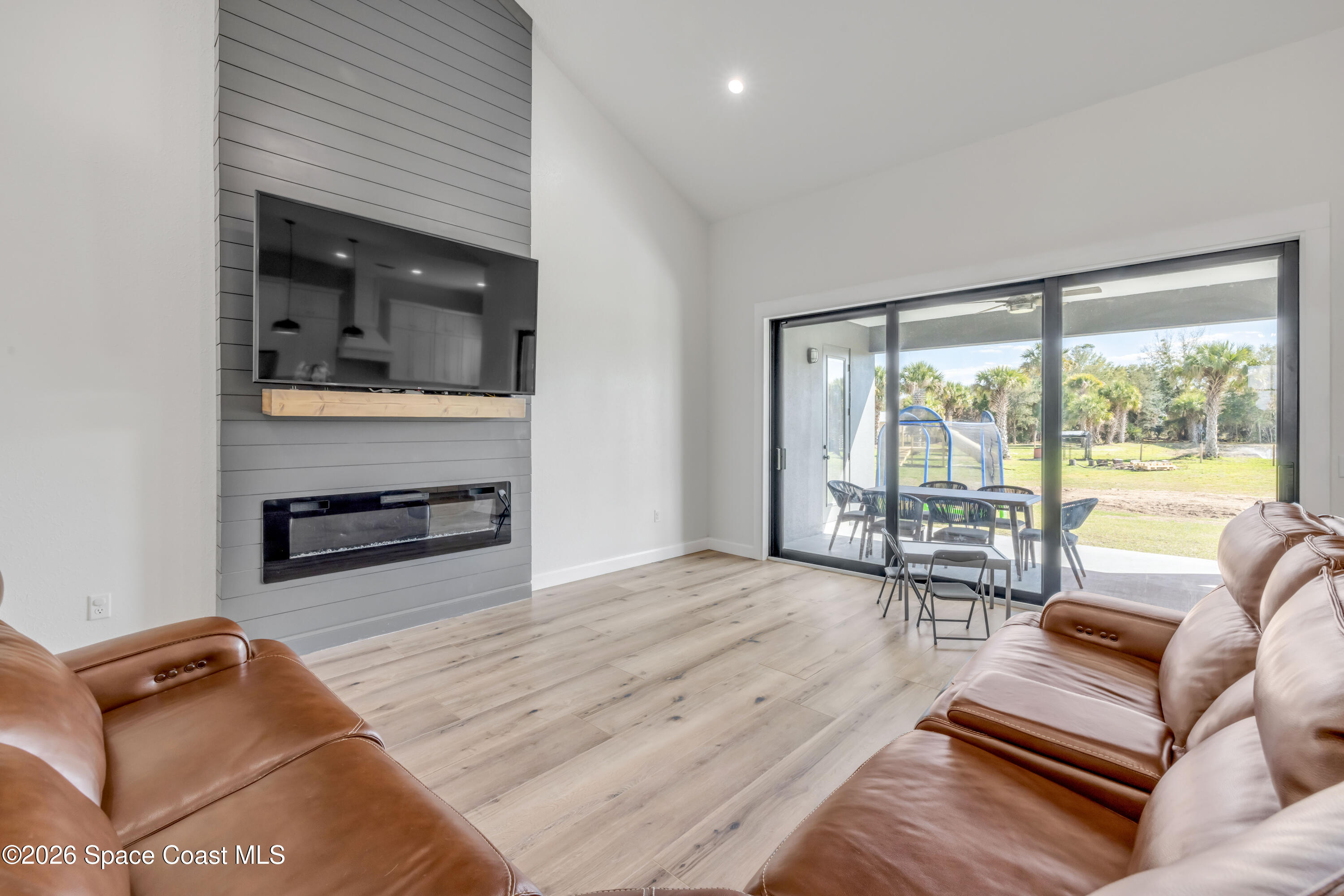 3395 Dunn Road Mims, FL 32754 - Photo 9 of 40 a living room with furniture and a flat screen tv