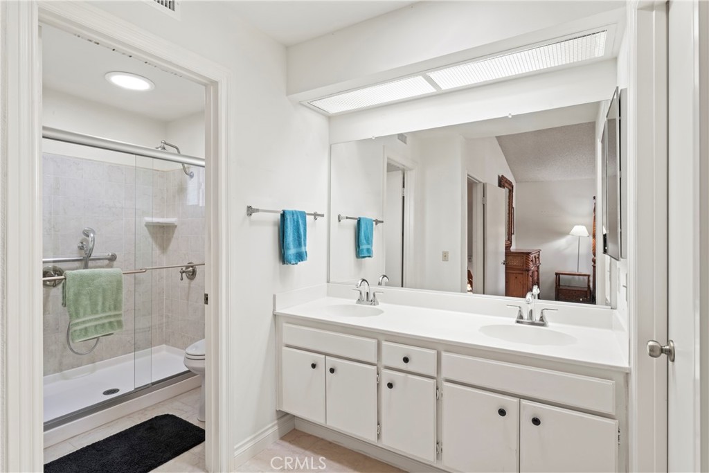 1749 Parkview Redlands, CA 92374 - Photo 32 of 55 a bathroom with a shower tub double vanity sink and mirror