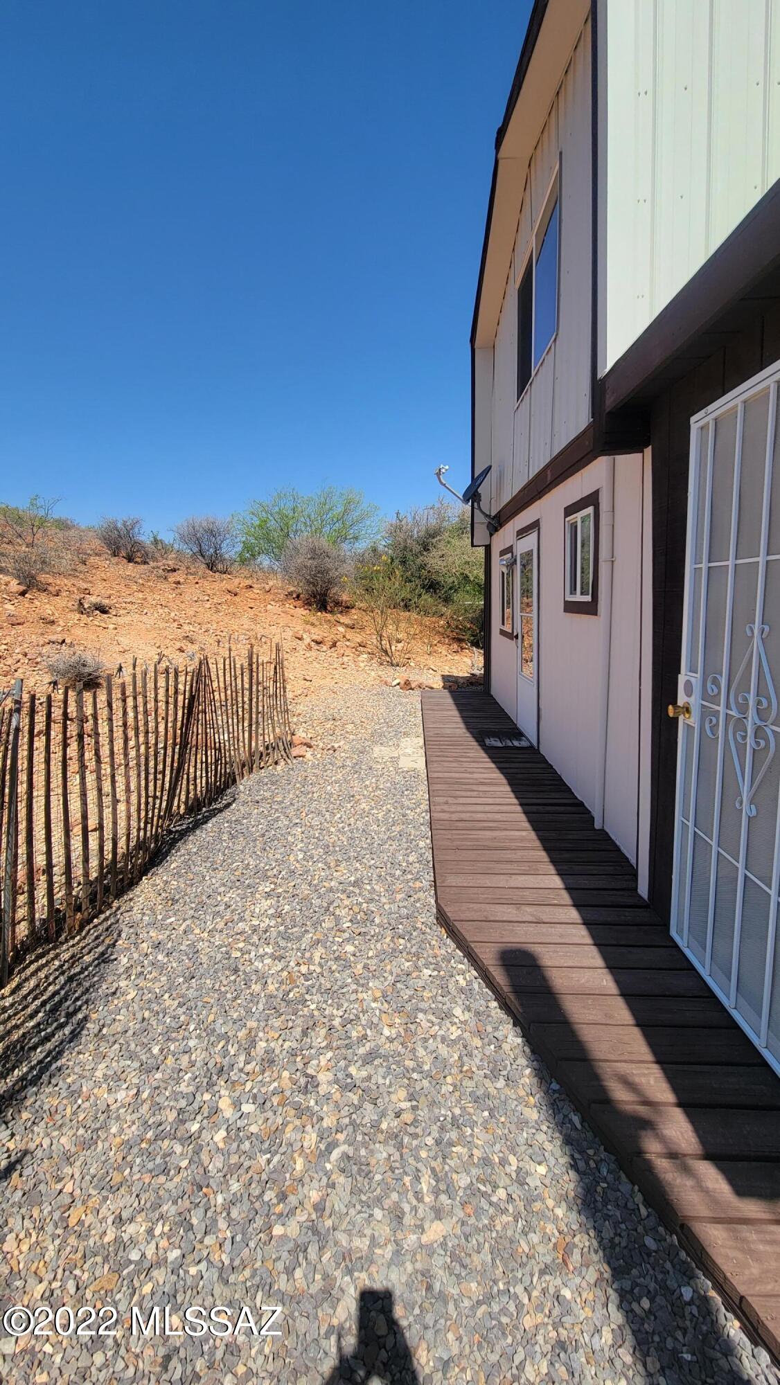 3399 Red Stag Road Pearce, AZ 85625 - Photo 32 of 47 a view of a house with a yard