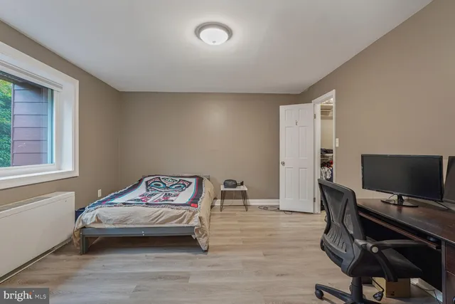 a bedroom with furniture and a window