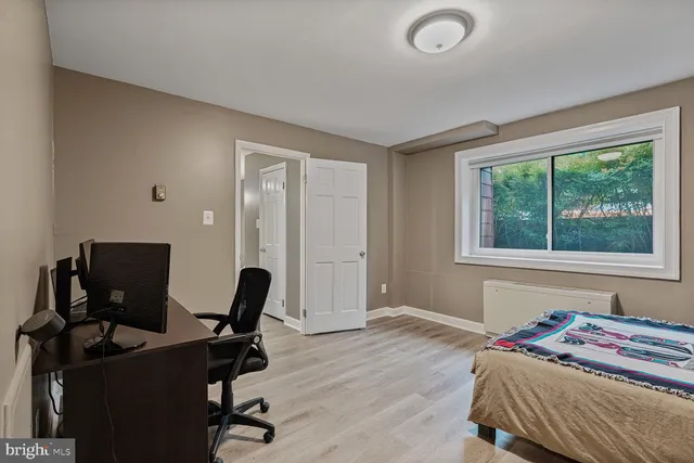 a bedroom with a workspace