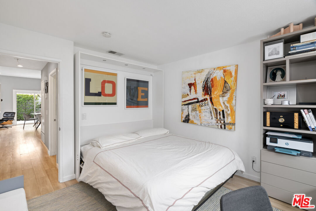 1450 East Racquet Club Road Palm Springs, CA 92262 - Photo 12 of 31 a bedroom with a bed and a painting on the wall