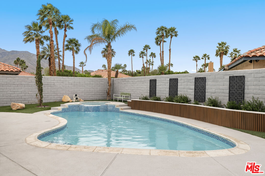 1450 East Racquet Club Road Palm Springs, CA 92262 - Photo 16 of 31 a view of a swimming pool with a lounge chair