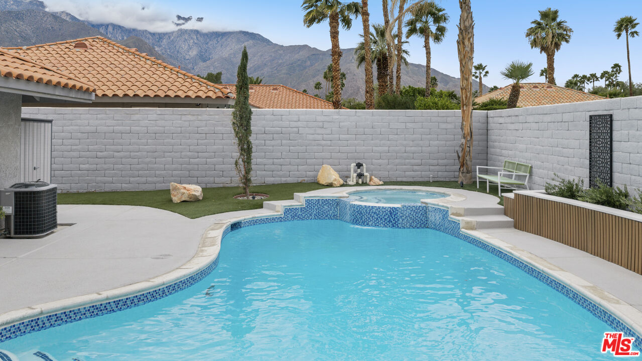 1450 East Racquet Club Road Palm Springs, CA 92262 - Photo 17 of 31 a view of a swimming pool with a patio