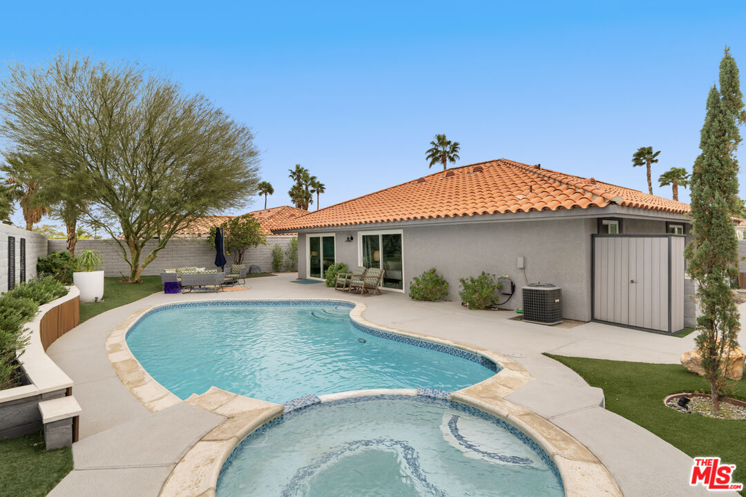 1450 East Racquet Club Road Palm Springs, CA 92262 - Photo 20 of 31 a view of a house with swimming pool and sitting area