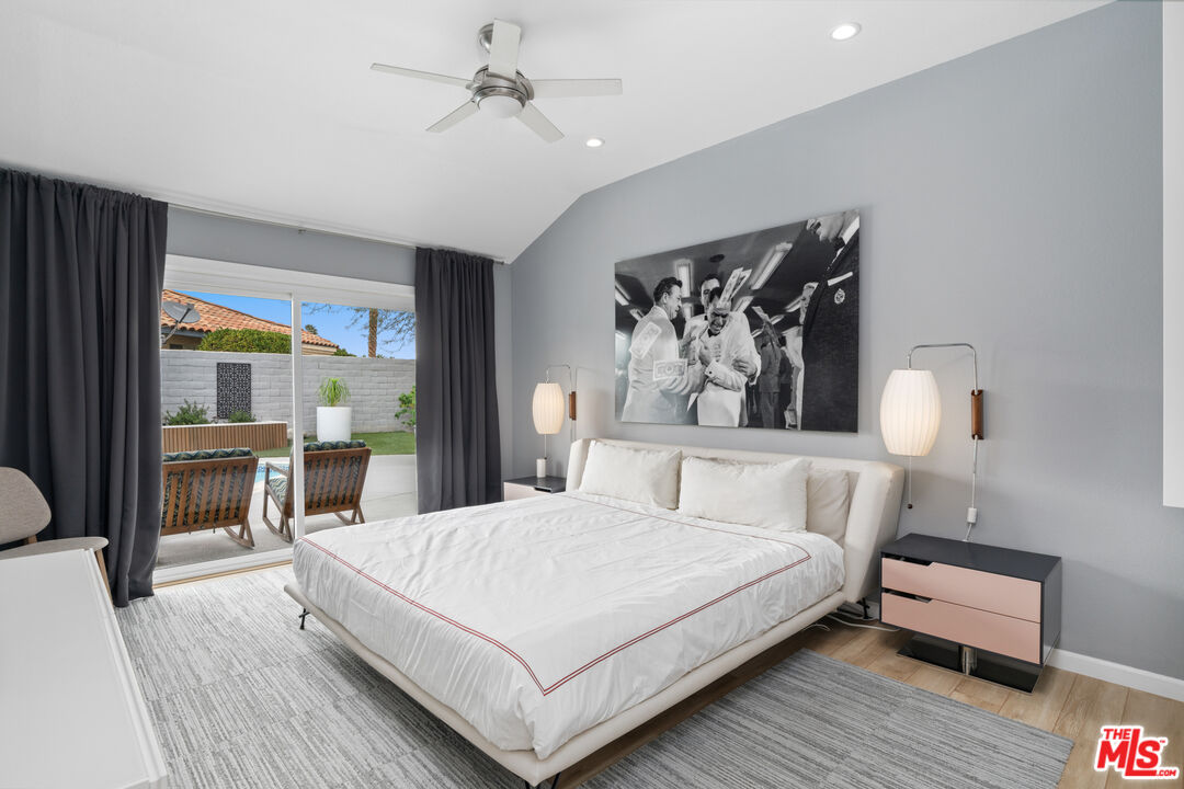 1450 East Racquet Club Road Palm Springs, CA 92262 - Photo 7 of 31 a bedroom with a bed and a table