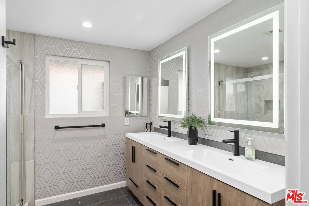 1450 East Racquet Club Road Palm Springs, CA 92262 - Photo 9 of 31 a bathroom with double vanity sink a mirror and a shower