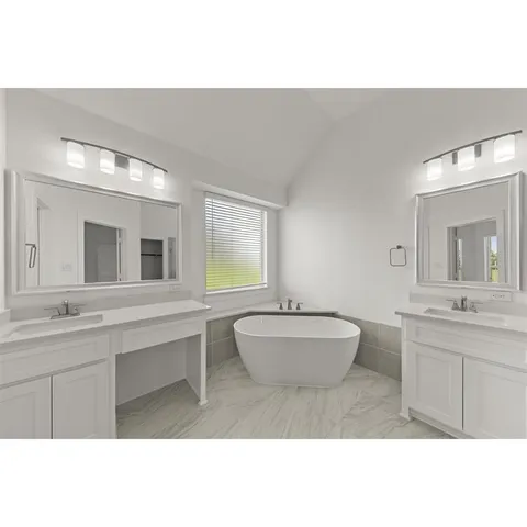 a en suite bathroom with a double vanity sink a mirror and a bathtub