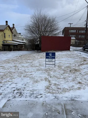 a view of a bench in the backyard