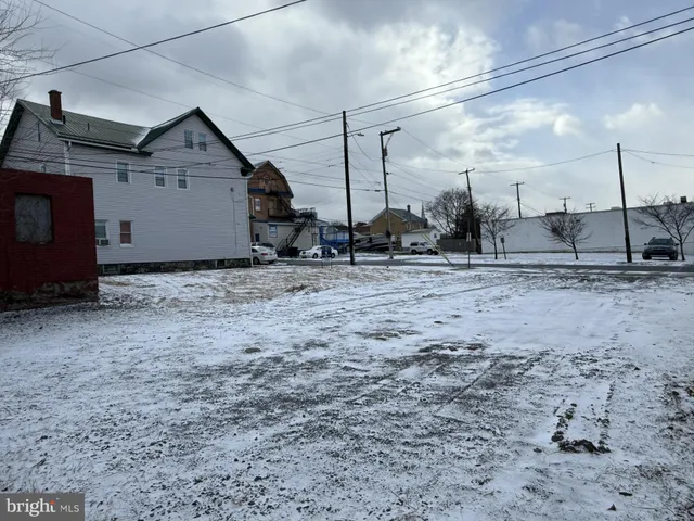 a view of a dirt road and a building