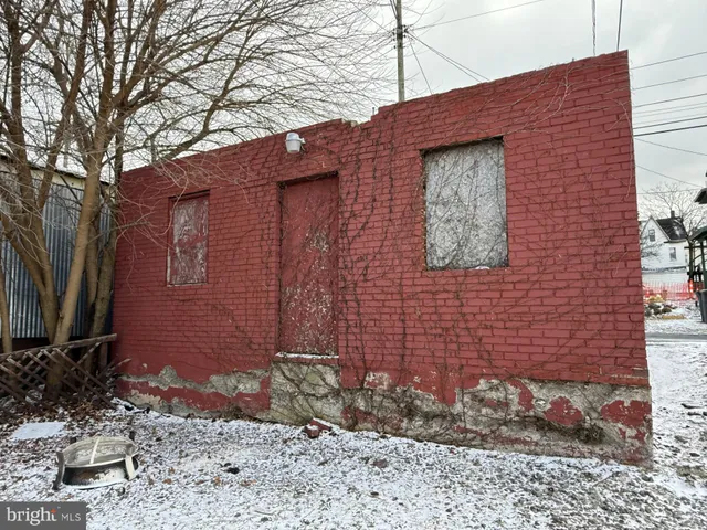 a brick building with a bench in front of it