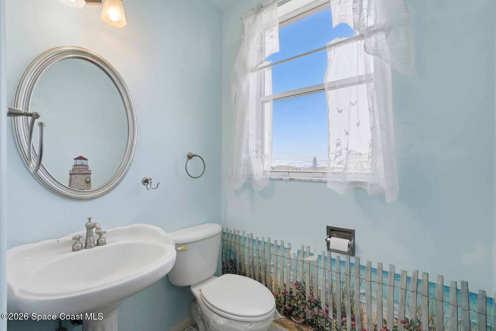 4688 South Atlantic Avenue Ponce Inlet, FL 32127 - Photo 26 of 83 a bathroom with a toilet a sink and a mirror