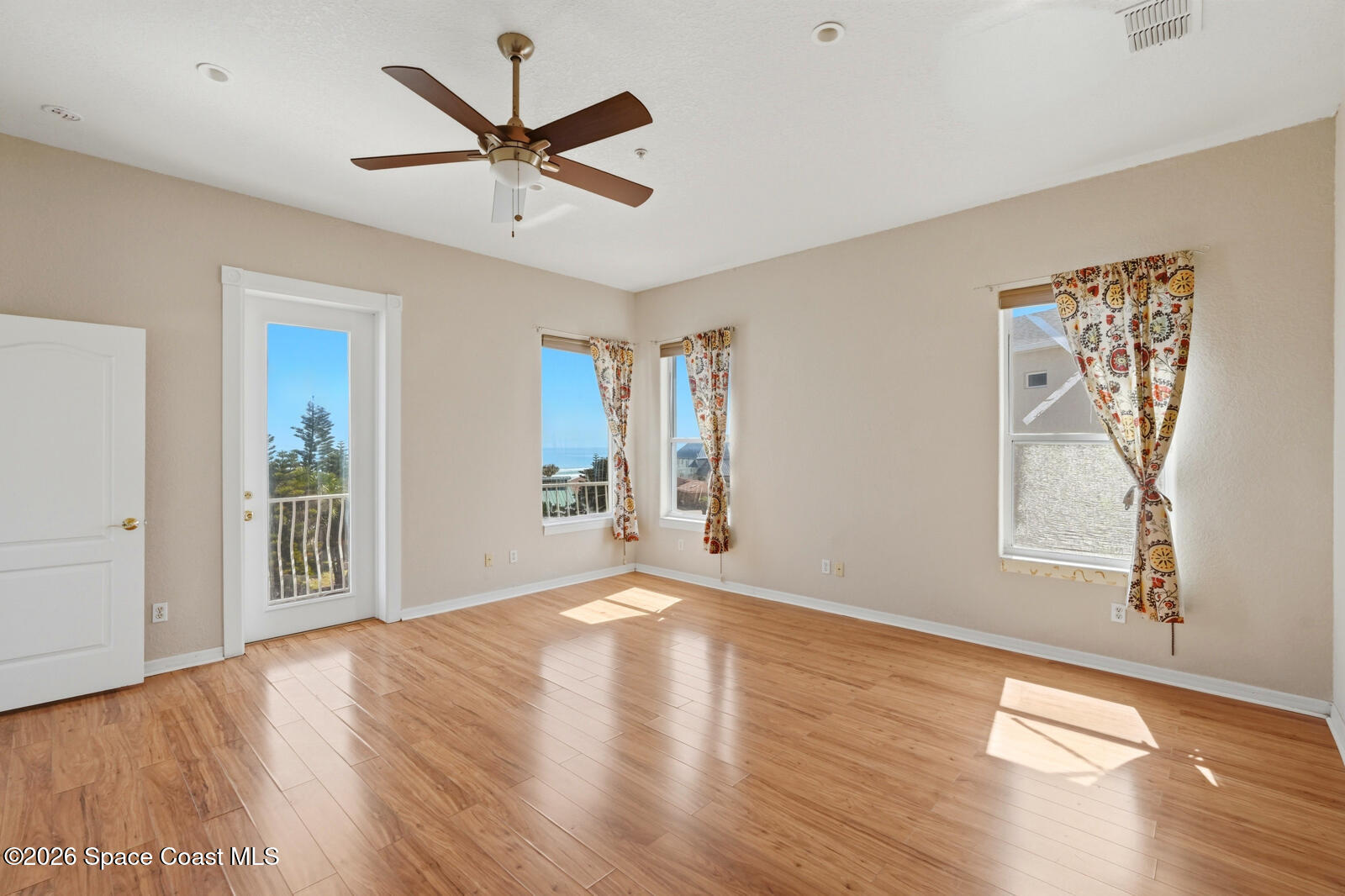 4688 South Atlantic Avenue Ponce Inlet, FL 32127 - Photo 28 of 83 a view of a livingroom with wooden floor and a ceiling fan
