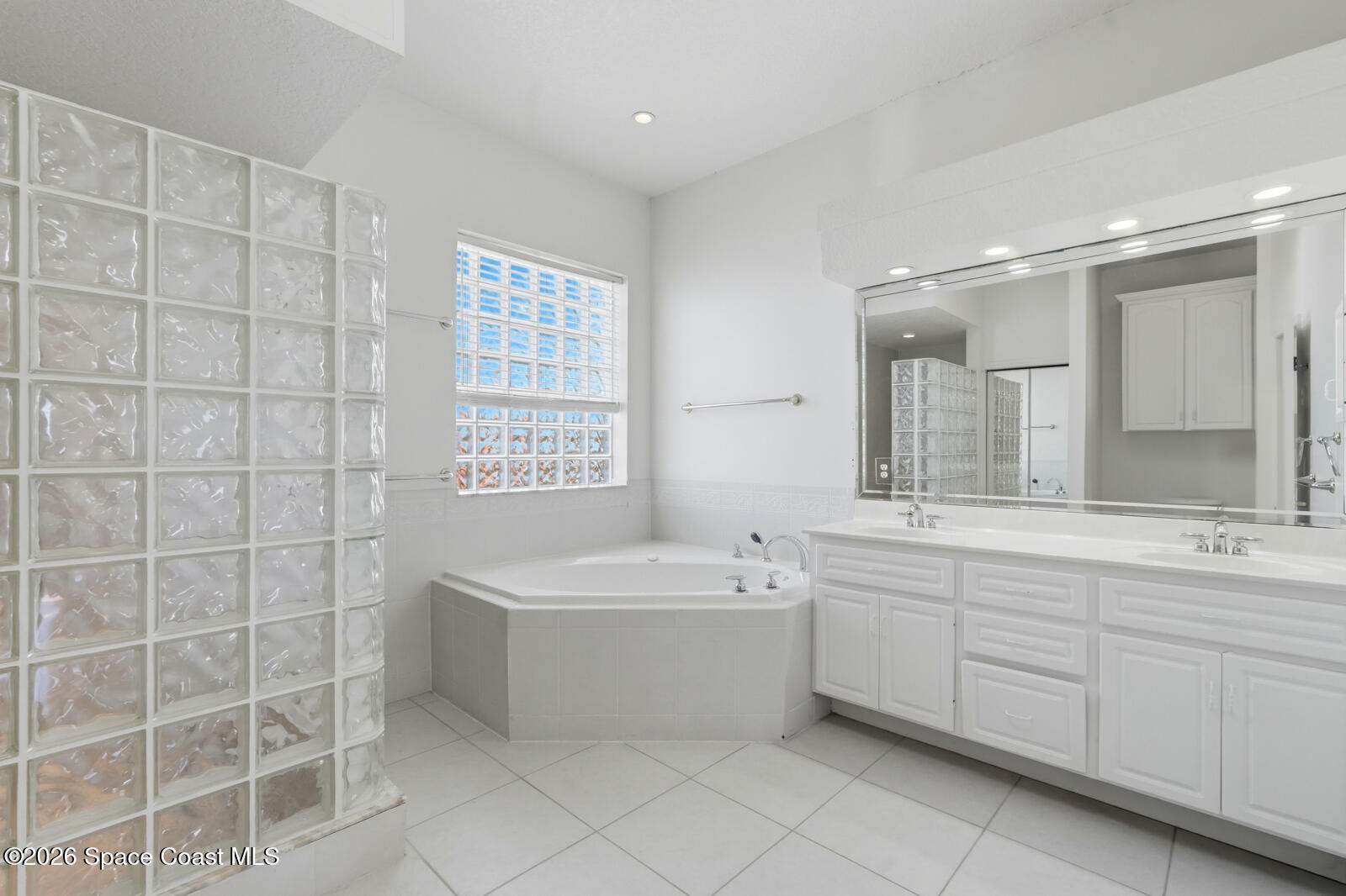 4688 South Atlantic Avenue Ponce Inlet, FL 32127 - Photo 29 of 83 a bathroom with a double vanity sink mirror and bathtub