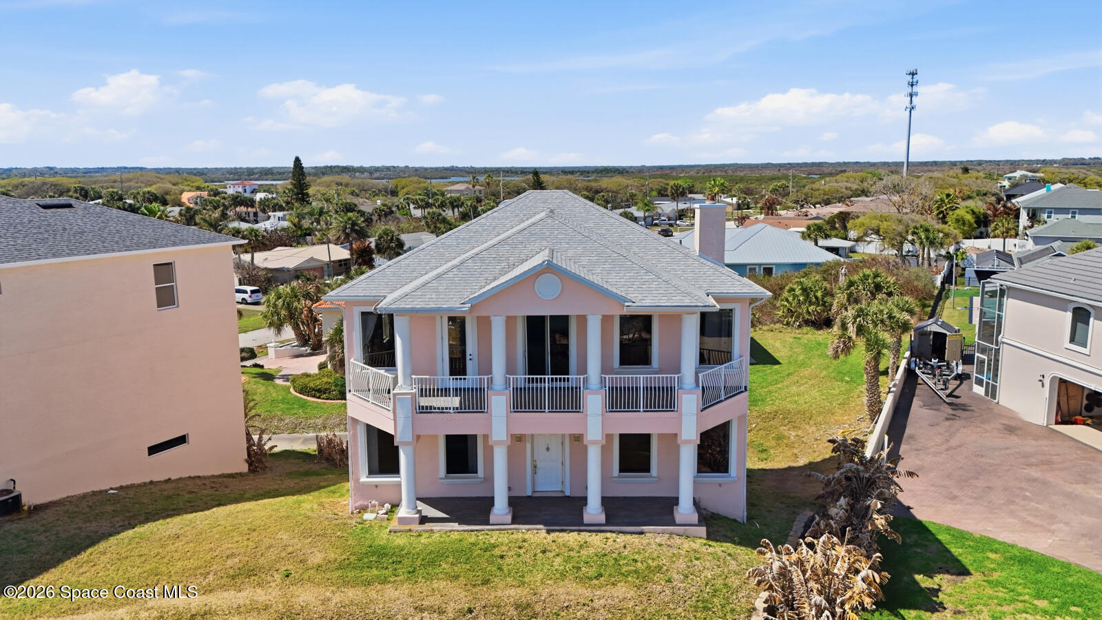 4688 South Atlantic Avenue Ponce Inlet, FL 32127 - Photo 3 of 83 a view of a brick house with a big yard and large trees