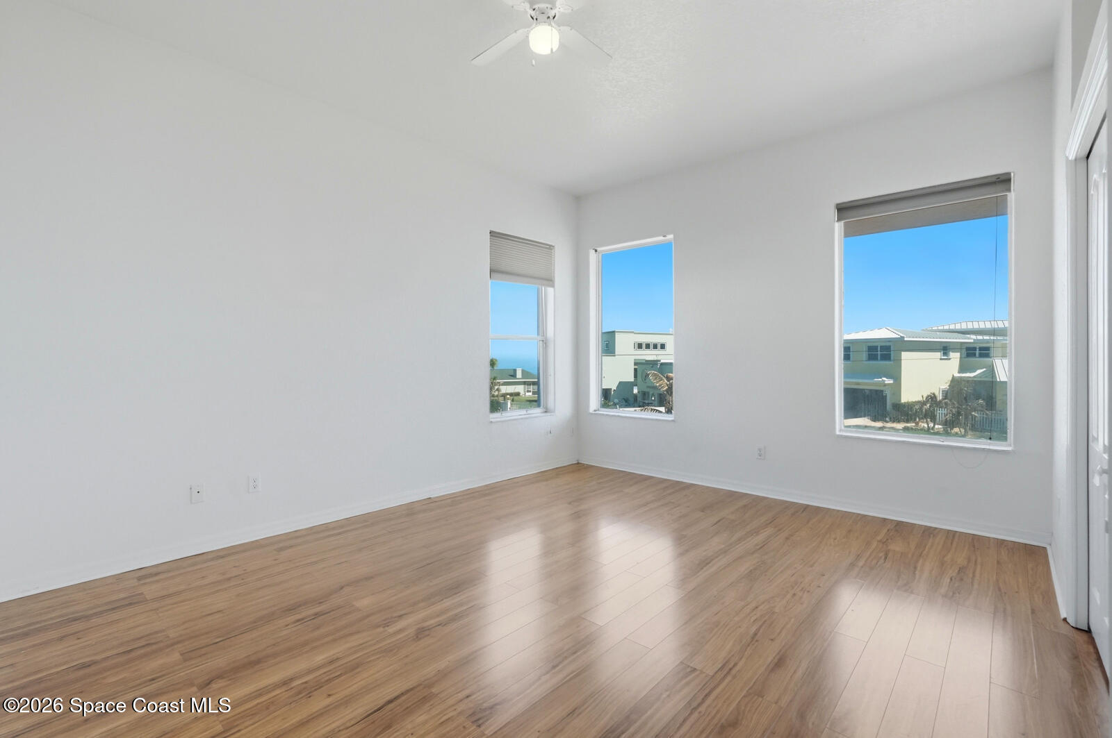 4688 South Atlantic Avenue Ponce Inlet, FL 32127 - Photo 38 of 83 a view of an empty room with wooden floor and a window