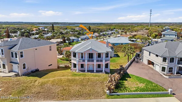a large kitchen with stainless steel appliances granite countertop a large counter top a sink and a refrigerator
