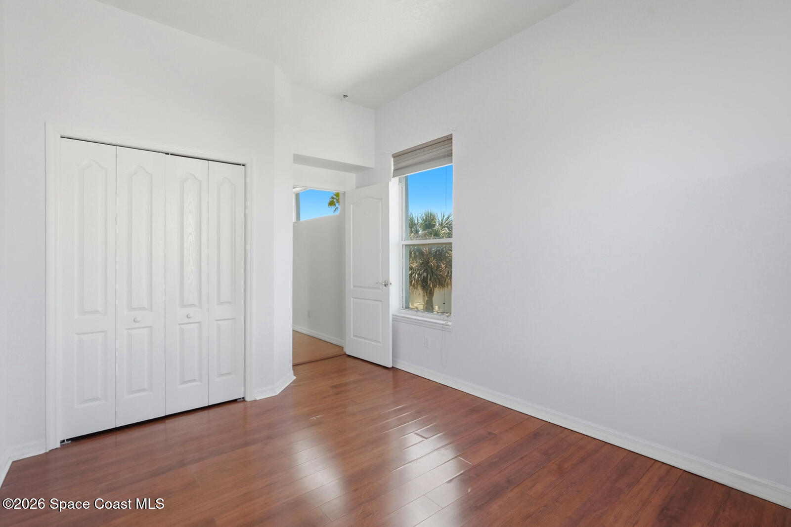 4688 South Atlantic Avenue Ponce Inlet, FL 32127 - Photo 43 of 83 a view of an empty room with wooden floor and a window