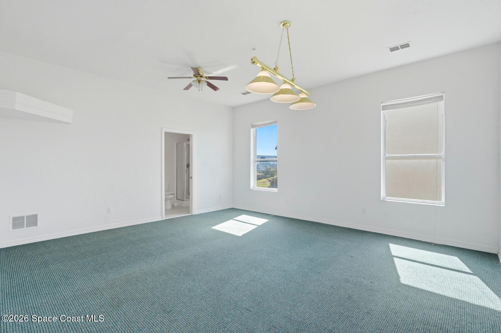 4688 South Atlantic Avenue Ponce Inlet, FL 32127 - Photo 45 of 83 an empty room with windows and fan