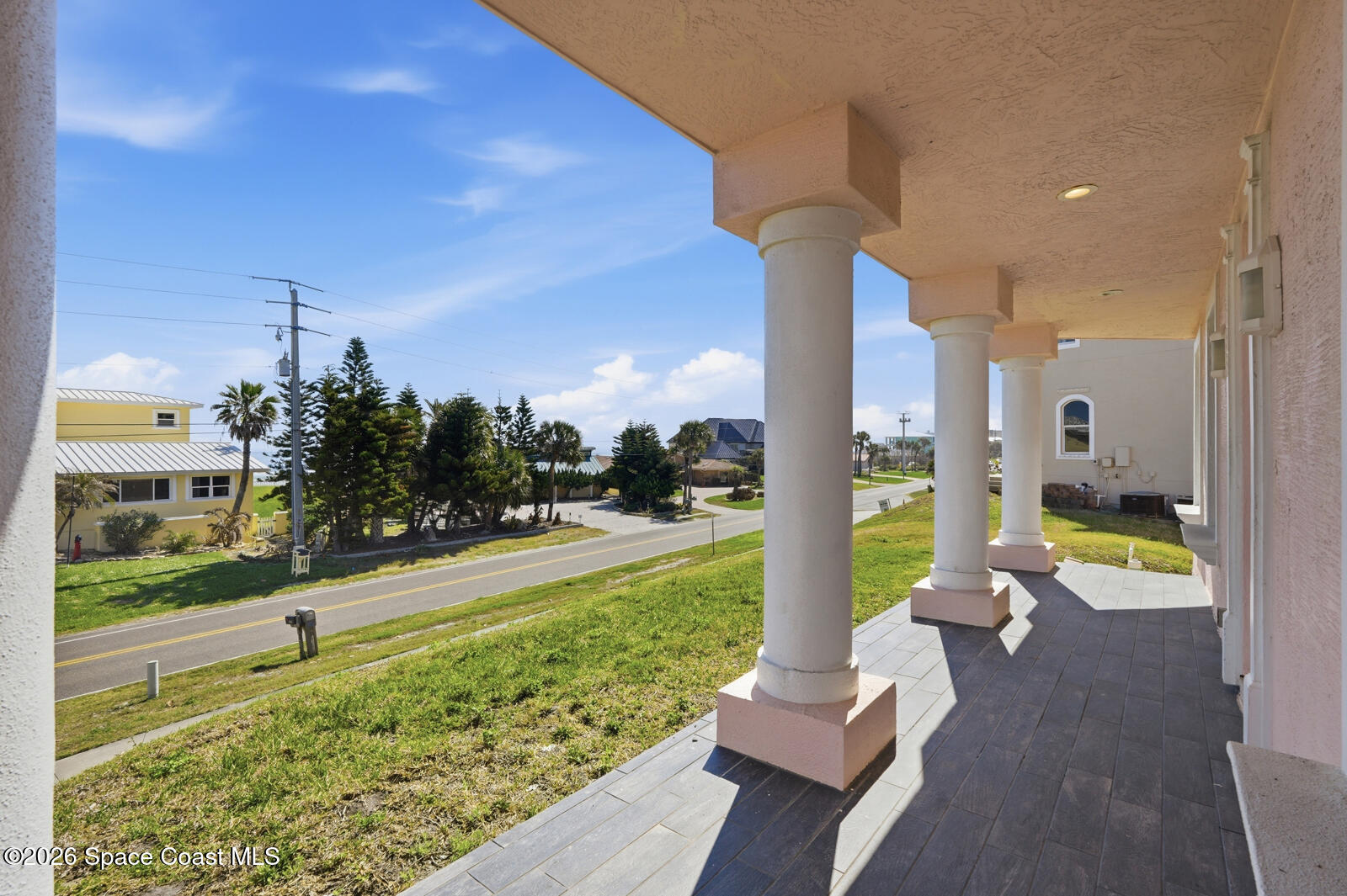 4688 South Atlantic Avenue Ponce Inlet, FL 32127 - Photo 54 of 83 a view of a patio with table and chairs potted plants