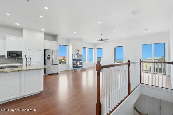 a kitchen with granite countertop white cabinets and stainless steel appliances
