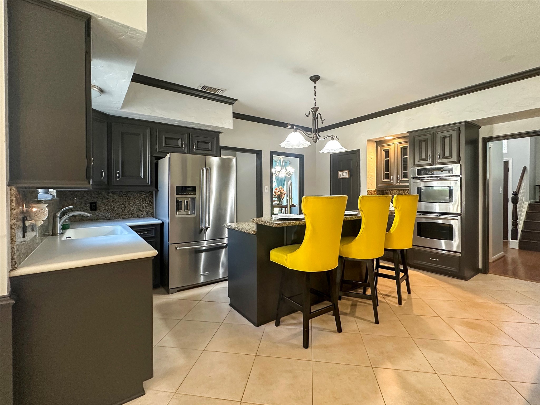 17003 Misty Creek Drive Spring, TX 77379 - Photo 15 of 50 a kitchen with stainless steel appliances kitchen island granite countertop a refrigerator a stove a sink a dining table and chairs with wooden floor