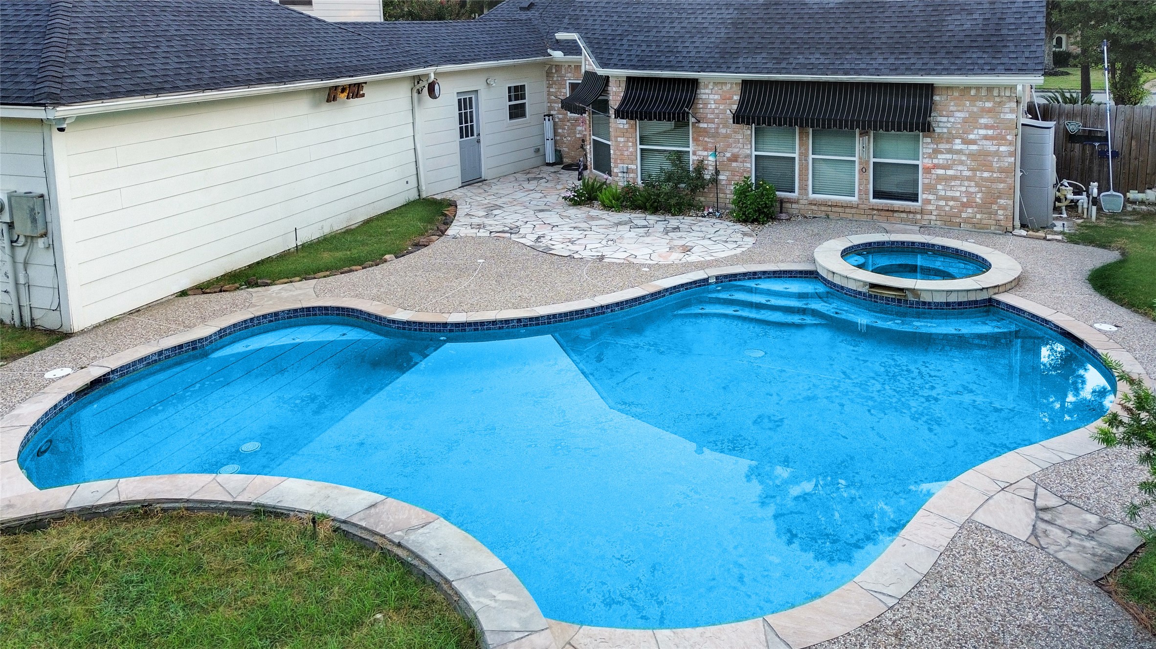 17003 Misty Creek Drive Spring, TX 77379 - Photo 2 of 50 Outdoor Living!
Living in Texas means enjoying the outdoors nearly year-round, and this backyard is designed for it. The sparkling pool features a connected Jacuzzi-style spa, perfect for relaxing after a long day or entertaining guests on the weekend. Slate stone adds room for table or gaming area.