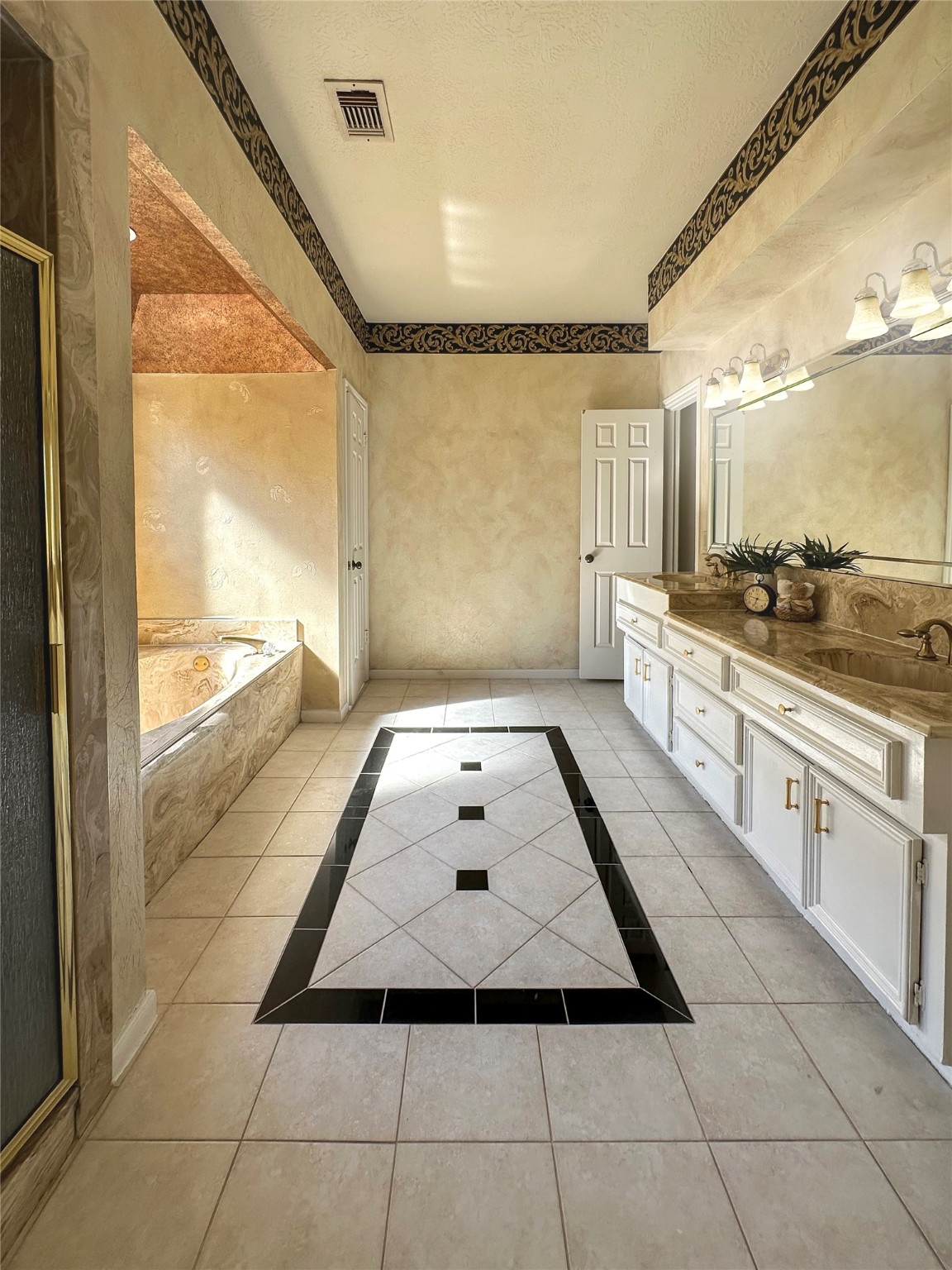 17003 Misty Creek Drive Spring, TX 77379 - Photo 26 of 50 a bathroom with a granite countertop sink a mirror and next to a window