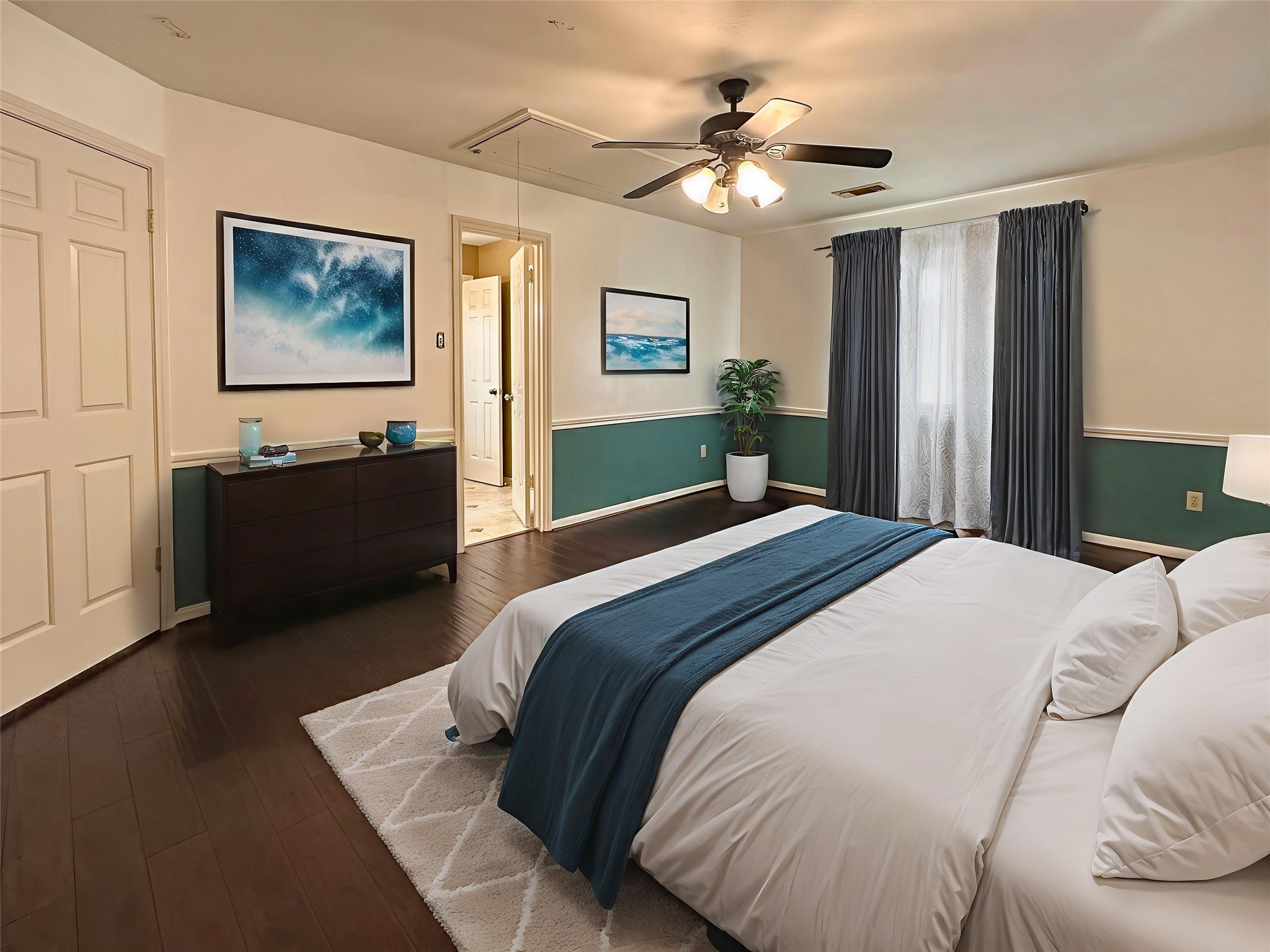 17003 Misty Creek Drive Spring, TX 77379 - Photo 28 of 50 a bedroom with a large bed and a chandelier