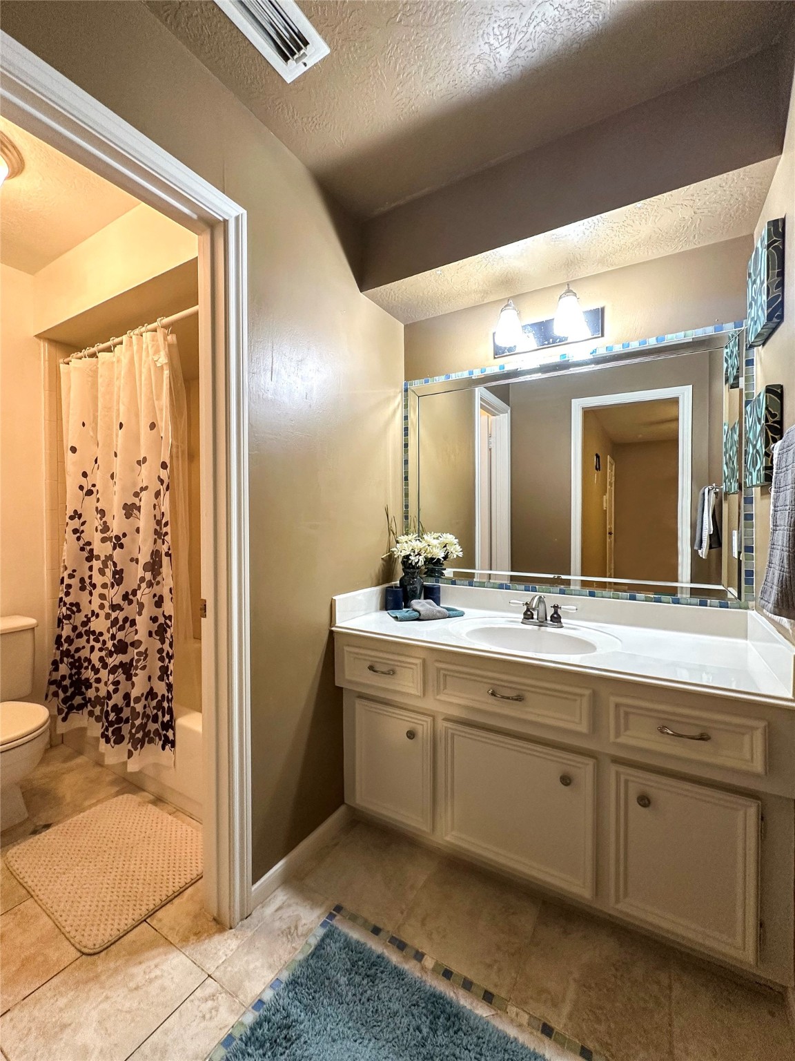 17003 Misty Creek Drive Spring, TX 77379 - Photo 32 of 50 a spacious bathroom with a double vanity sink and a mirror