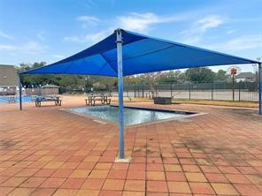 17003 Misty Creek Drive Spring, TX 77379 - Photo 42 of 50 a view of a swimming pool with a bench and lawn chairs