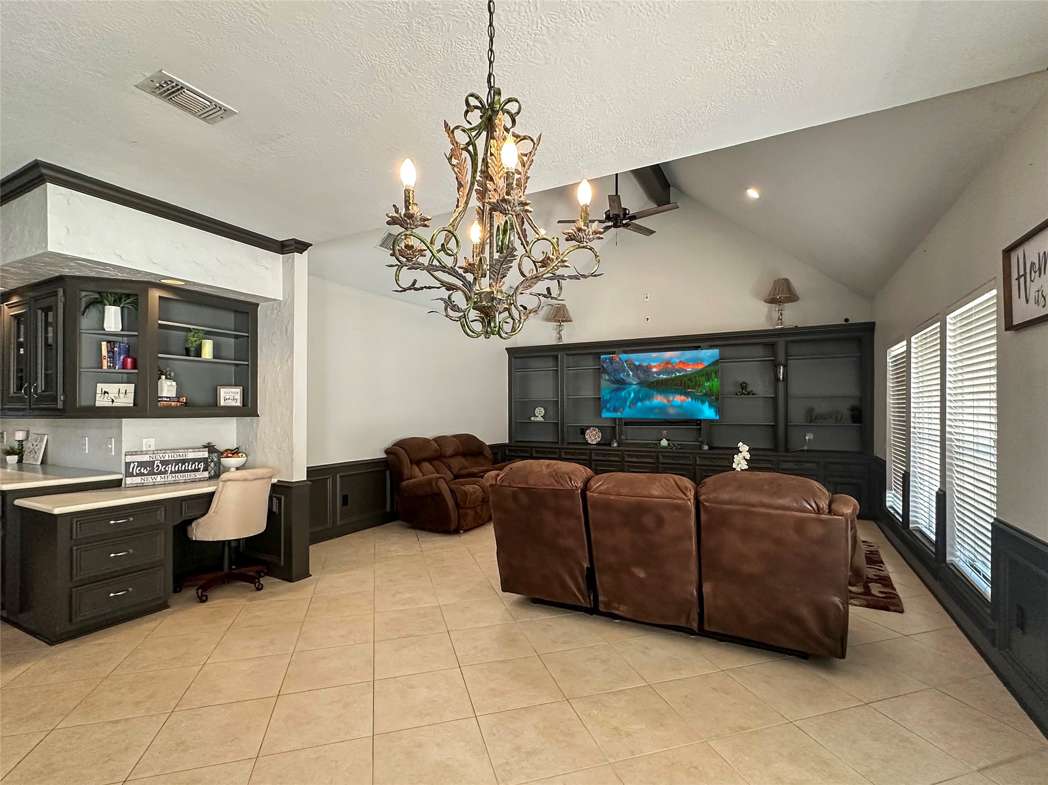17003 Misty Creek Drive Spring, TX 77379 - Photo 8 of 50 a living room with furniture a chandelier and a flat screen tv
