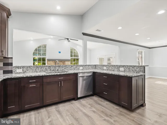 a bathroom with a granite countertop double vanity and a sink