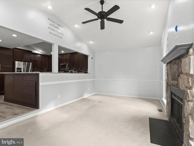 a kitchen with stainless steel appliances granite countertop a refrigerator a sink a stove and oven