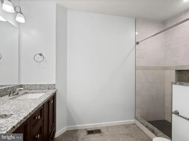 a bathroom with a shower and a sink