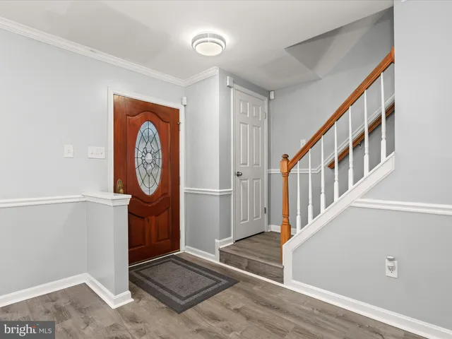a view of an entryway with wooden floor