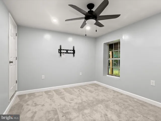 a view of a house with a yard balcony and a tree