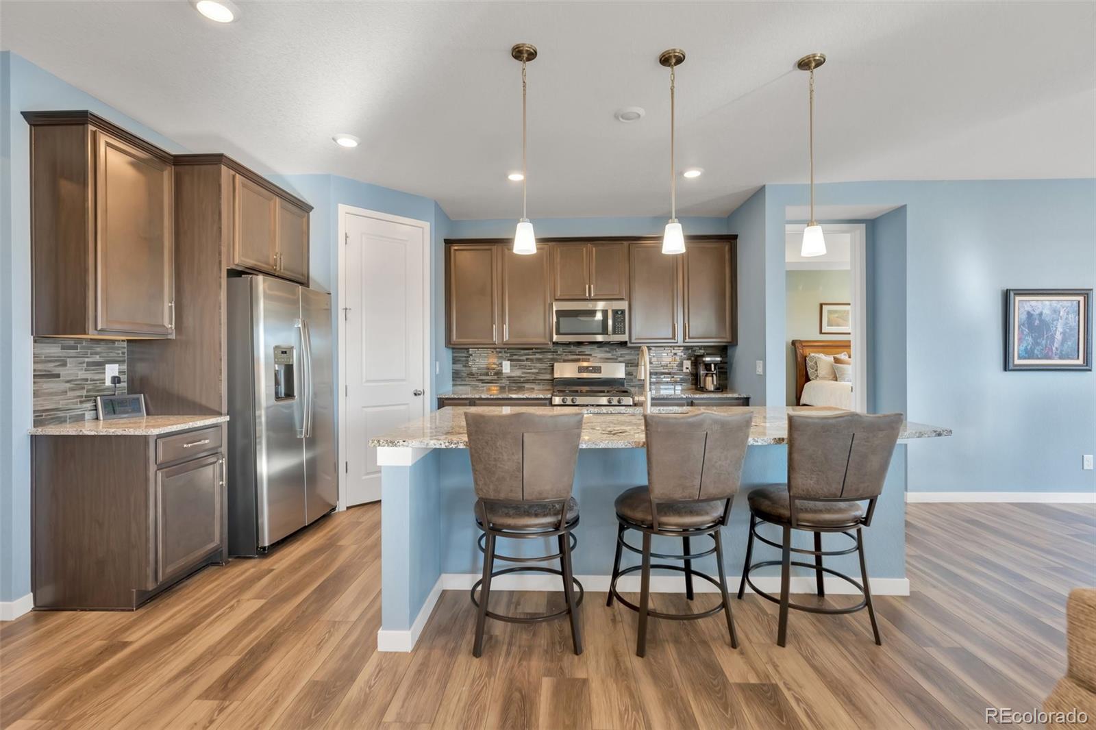 1122 Highpoint Trail Elizabeth, CO 80107 - Photo 14 of 45 a dining room filled chandelier and wooden floor