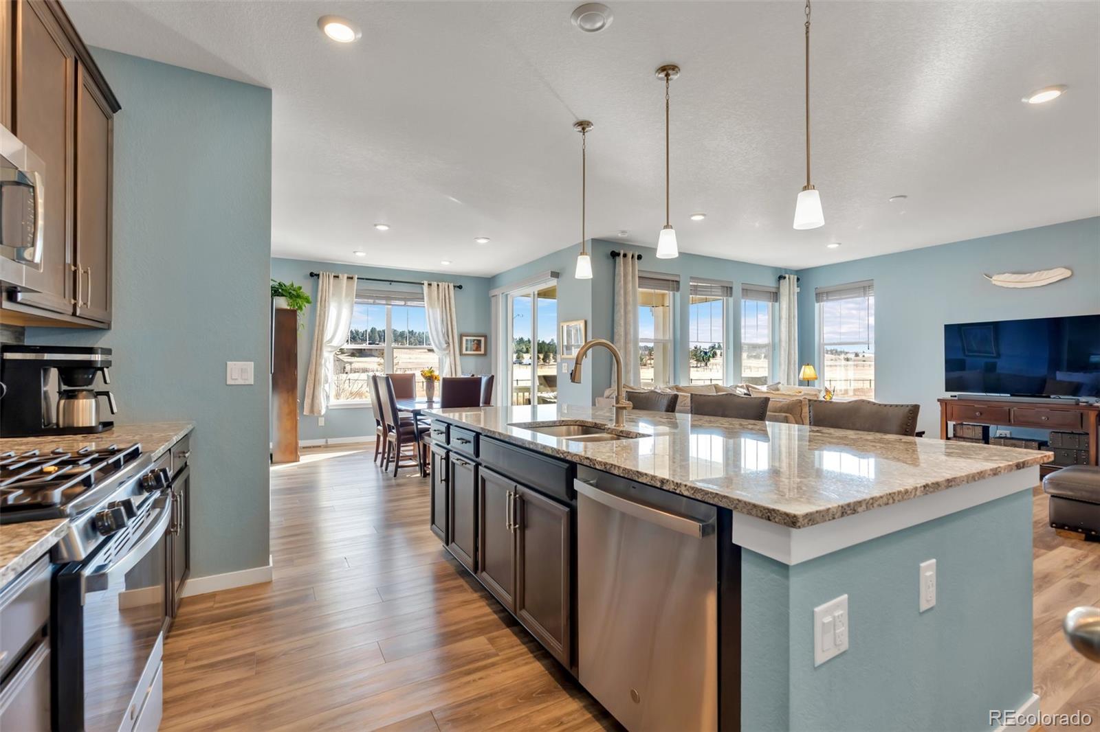 1122 Highpoint Trail Elizabeth, CO 80107 - Photo 16 of 45 a kitchen with lots of counter space a sink appliances and living room view