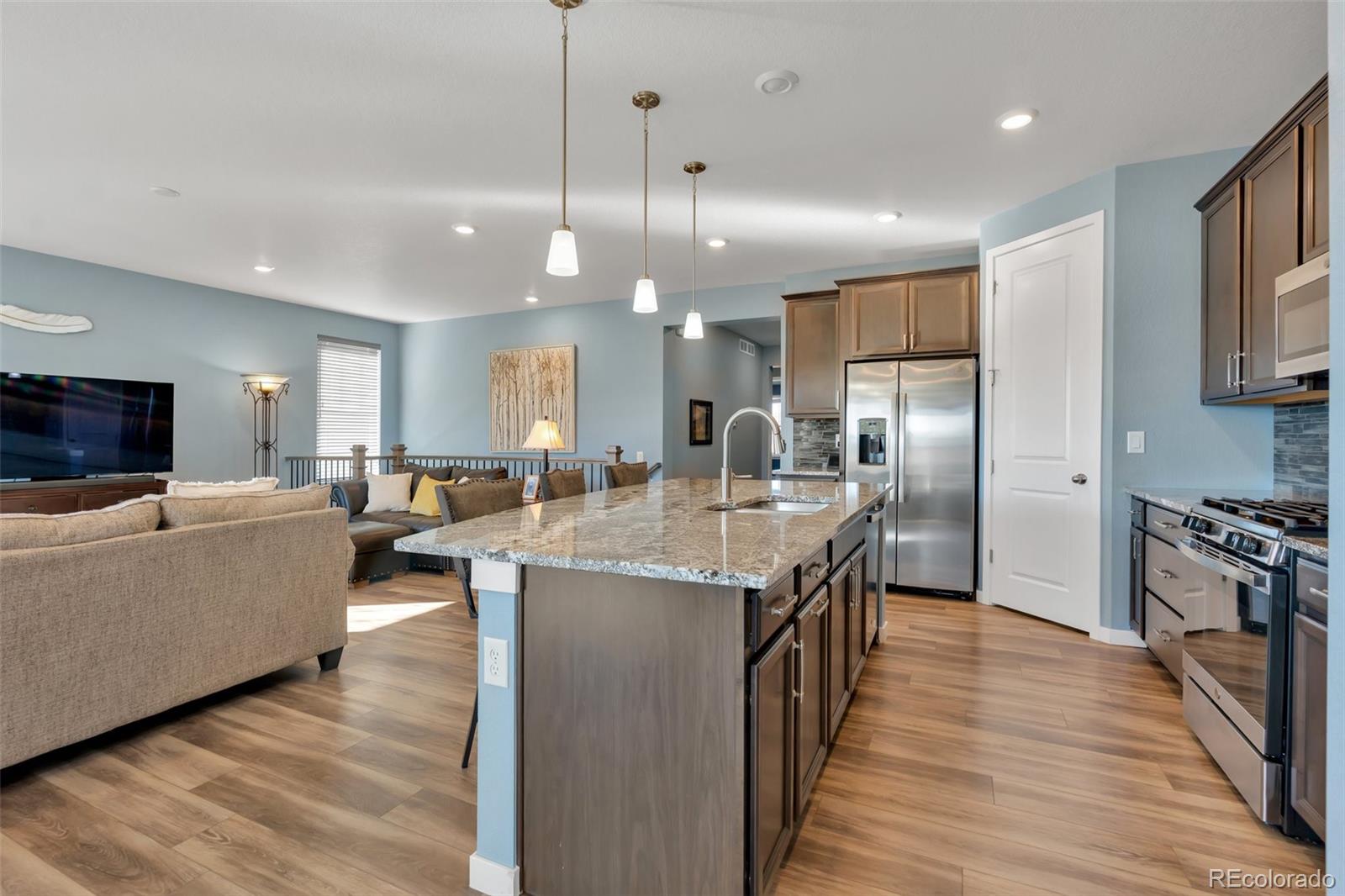 1122 Highpoint Trail Elizabeth, CO 80107 - Photo 18 of 45 a kitchen with counter top space a sink appliances and cabinets