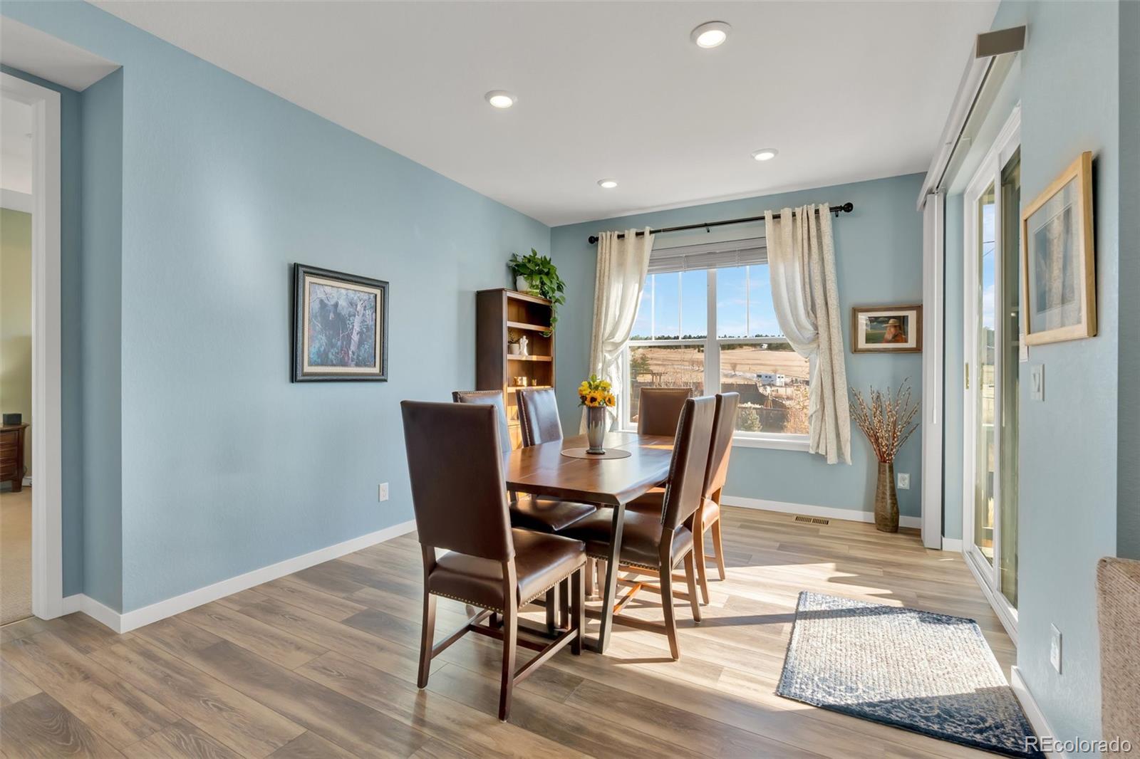 1122 Highpoint Trail Elizabeth, CO 80107 - Photo 20 of 45 a view of a dining room with furniture and wooden floor